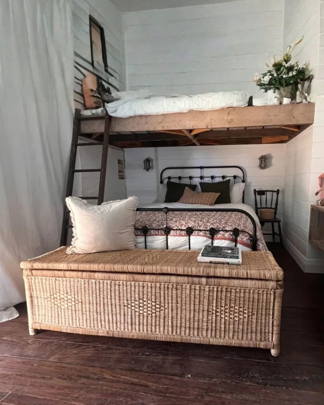 Bedroom with a loft bed and wicker bench.