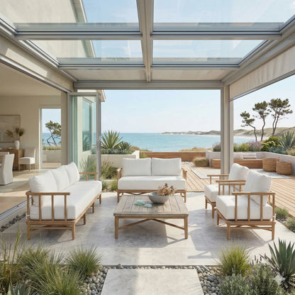 Modern outdoor patio with white furniture and a view of the ocean.