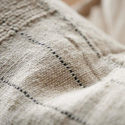 Close-up of textured fabric with black stitching details