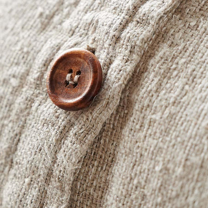 Close-up of a wooden button on beige fabric