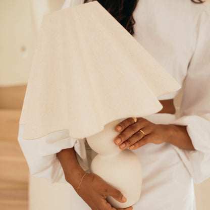 Person holding mila table lamp or with a neutral background