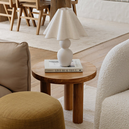 Modern living room with wooden table, chairs, and a lamp.