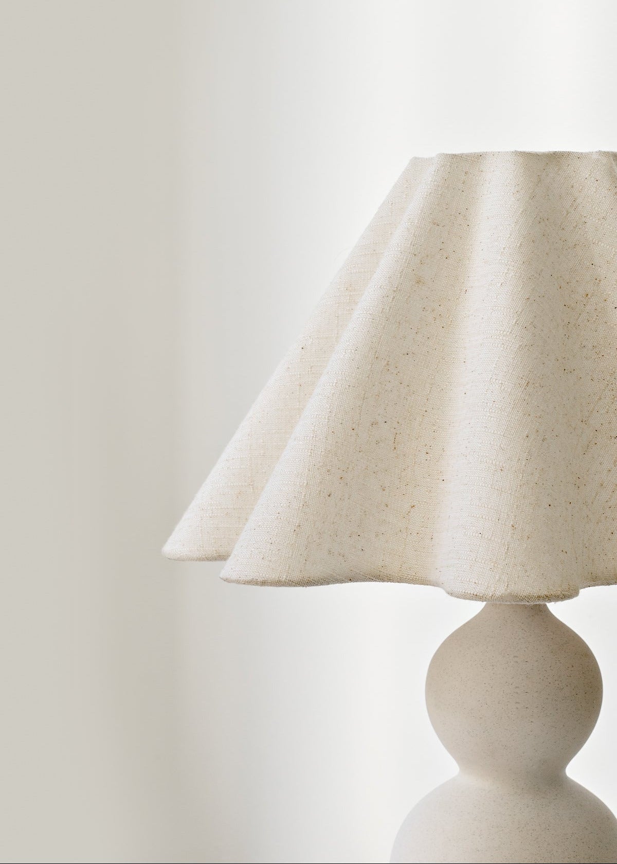 Mila lamp with a textured shade on a plain background