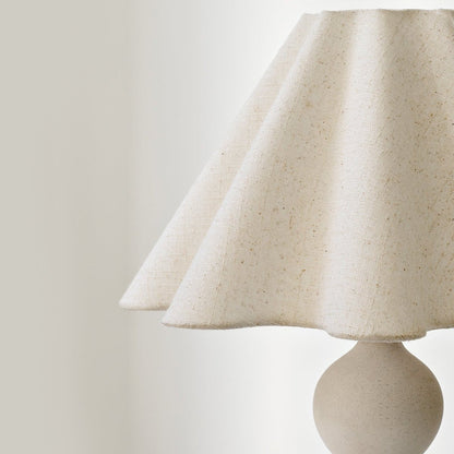 Mila lamp with a textured shade on a plain background
