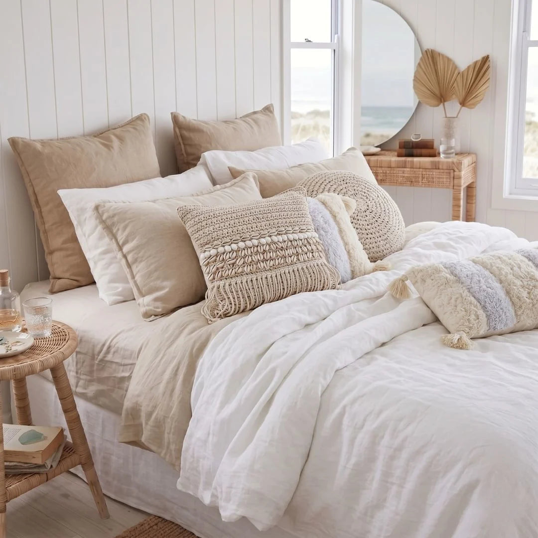 Neatly made bed with decorative pillows in a bedroom setting