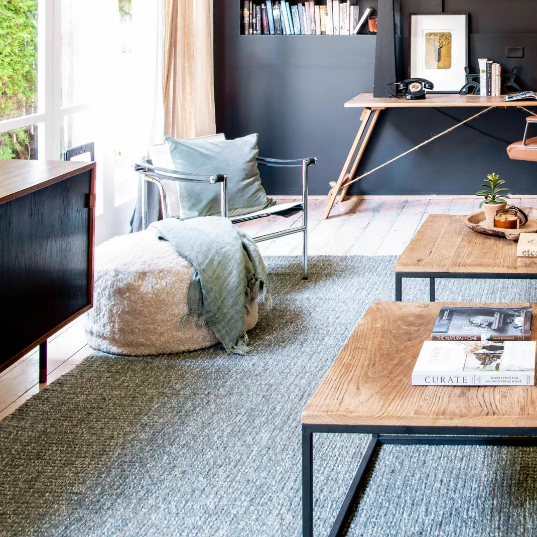 Modern living room with a sofa, coffee table, and decorative items.