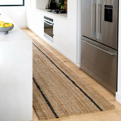 Kitchen with a woven runner rug on a wooden floor