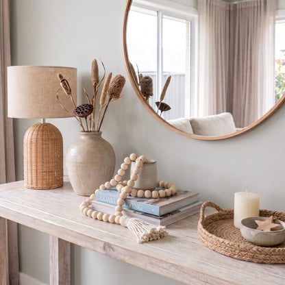 Natural wooden beaded looped garland styled on a console in a modern home.
