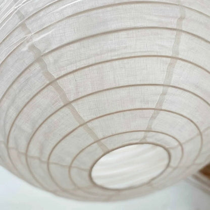Close-up of a white linen pendant with concentric circular patterns