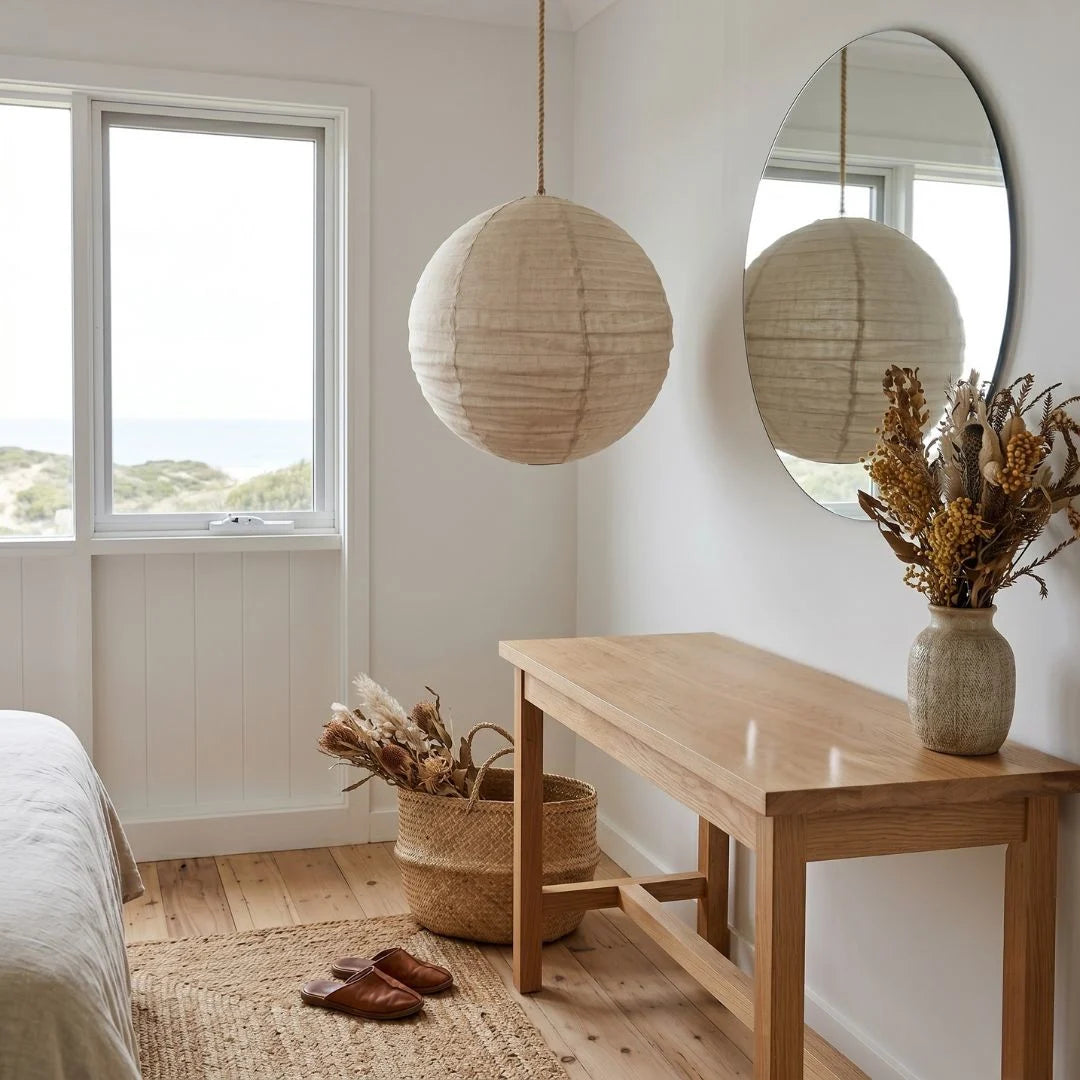 Nautical-themed room with wooden bench, spherical mirror, and decorative items.