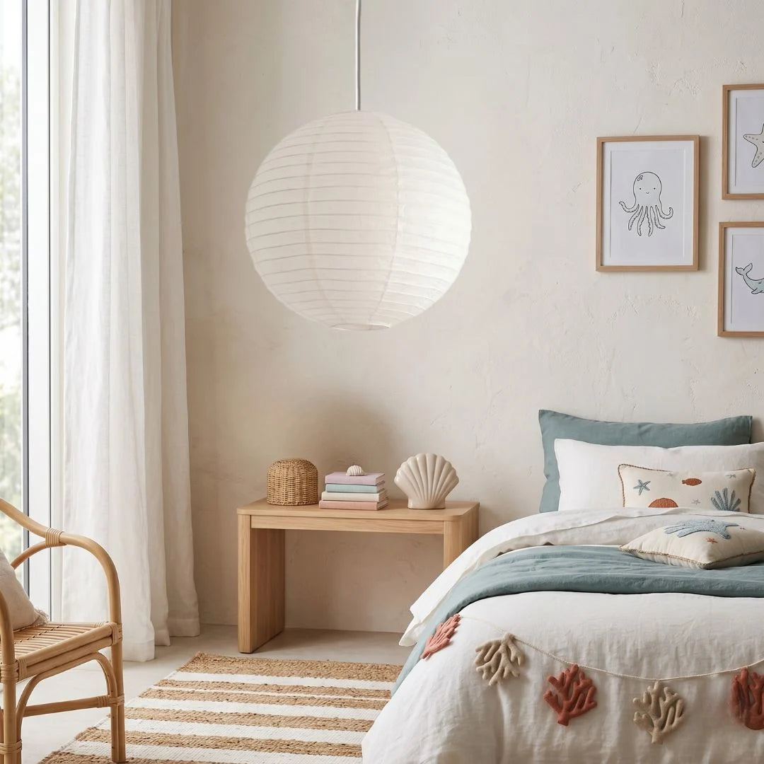 Cozy bedroom with a bed, side table, white round linen pendant and decorative elements.