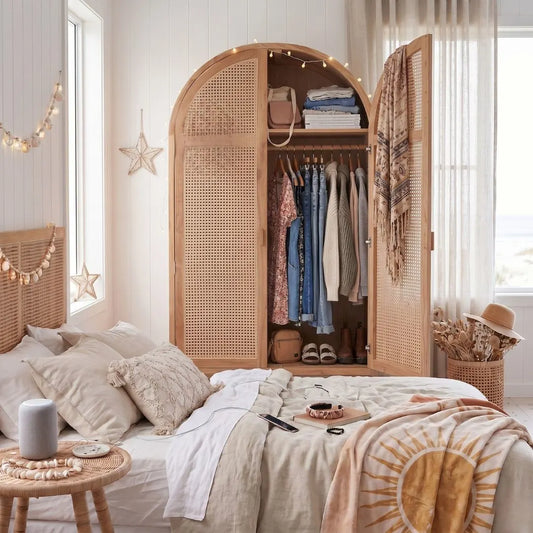Bedroom with wooden wardrobe, bed, and decorative items.