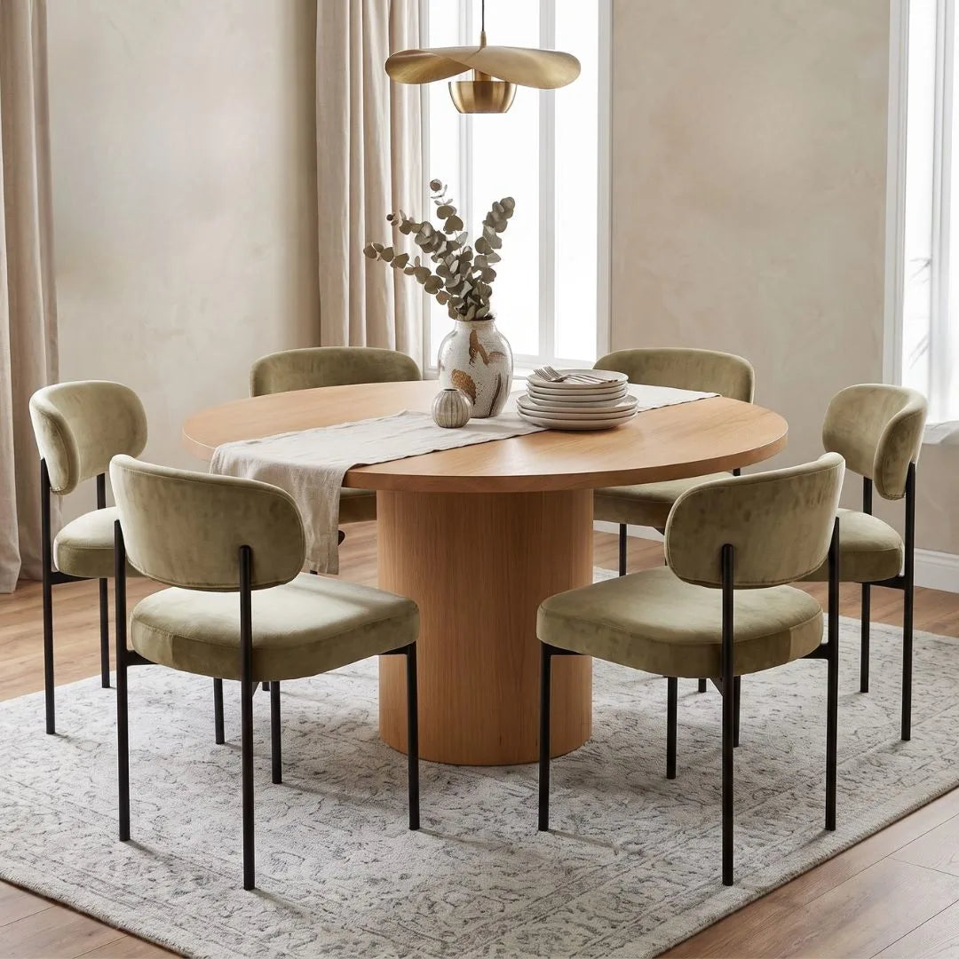 Dining room with a wooden table and beige chairs on a light rug.