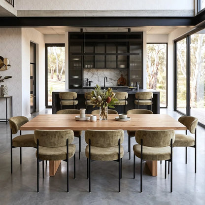 Modern dining area with wooden table and chairs in a stylish kitchen.