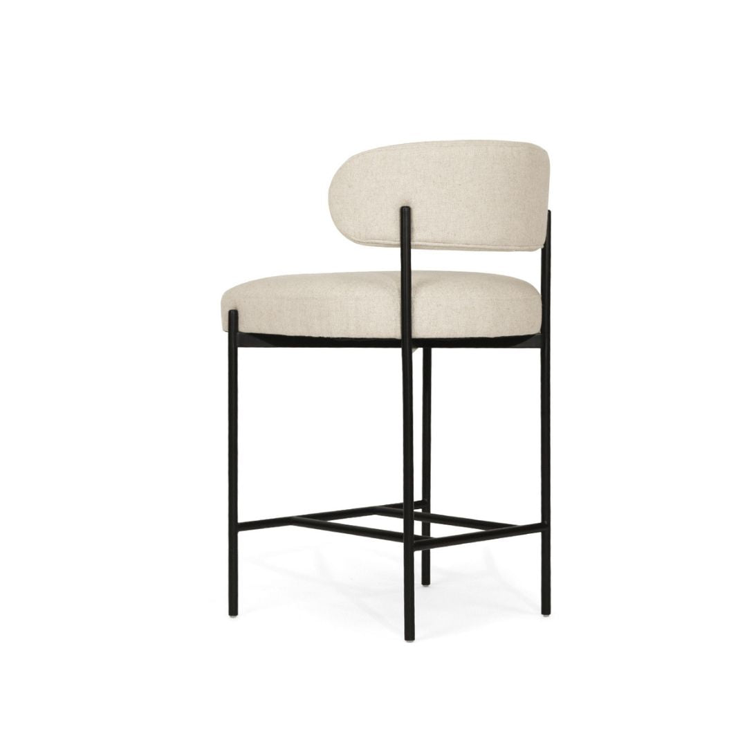 Bar stool with beige cushioned seat and backrest on a white background