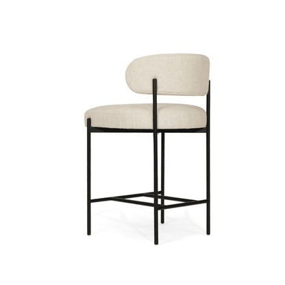 Bar stool with beige cushioned seat and backrest on a white background