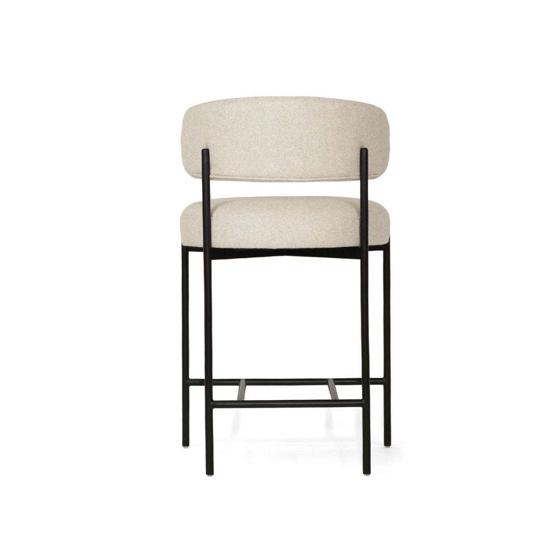 Beige bar stool with black metal frame on a white background