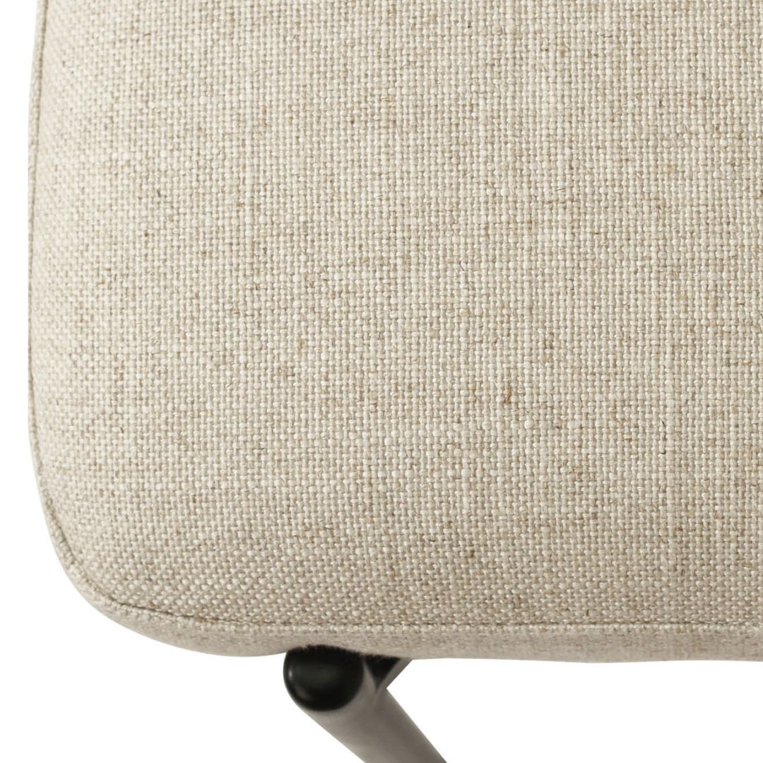 Close-up of a beige fabric chair seat with a white background