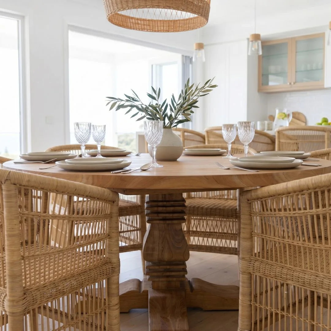 Dining room with wooden table and chairs, set for a meal.