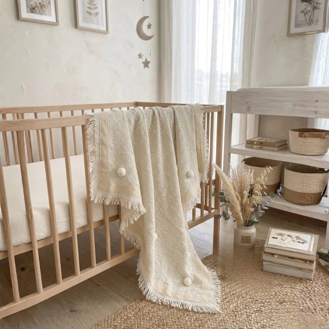 Nursery room with wooden crib, decorative elements, and a shelf.