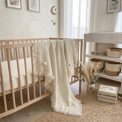 Nursery room with wooden crib, decorative elements, and a shelf.