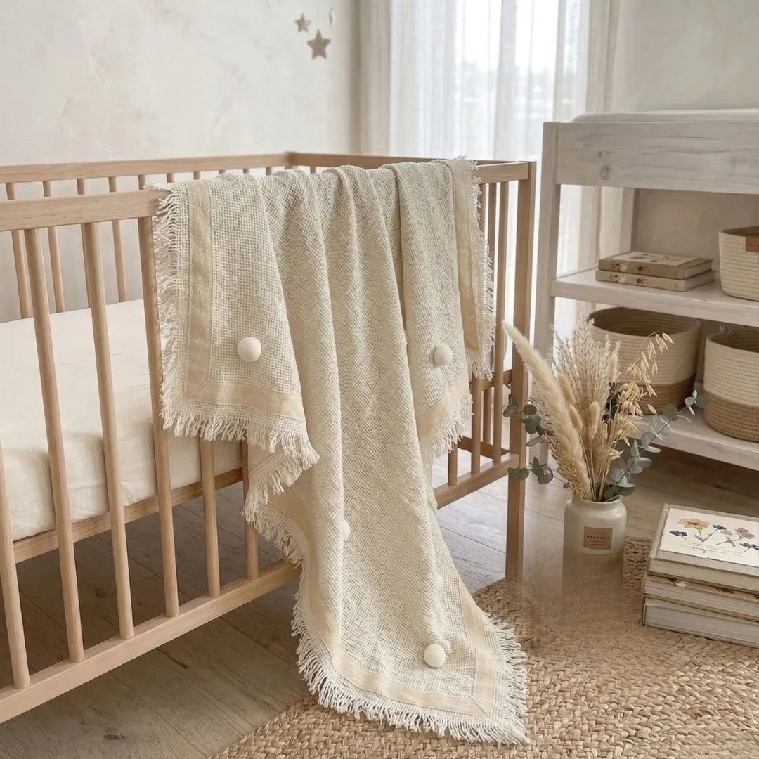Nursery room with wooden crib and decorative blanket
