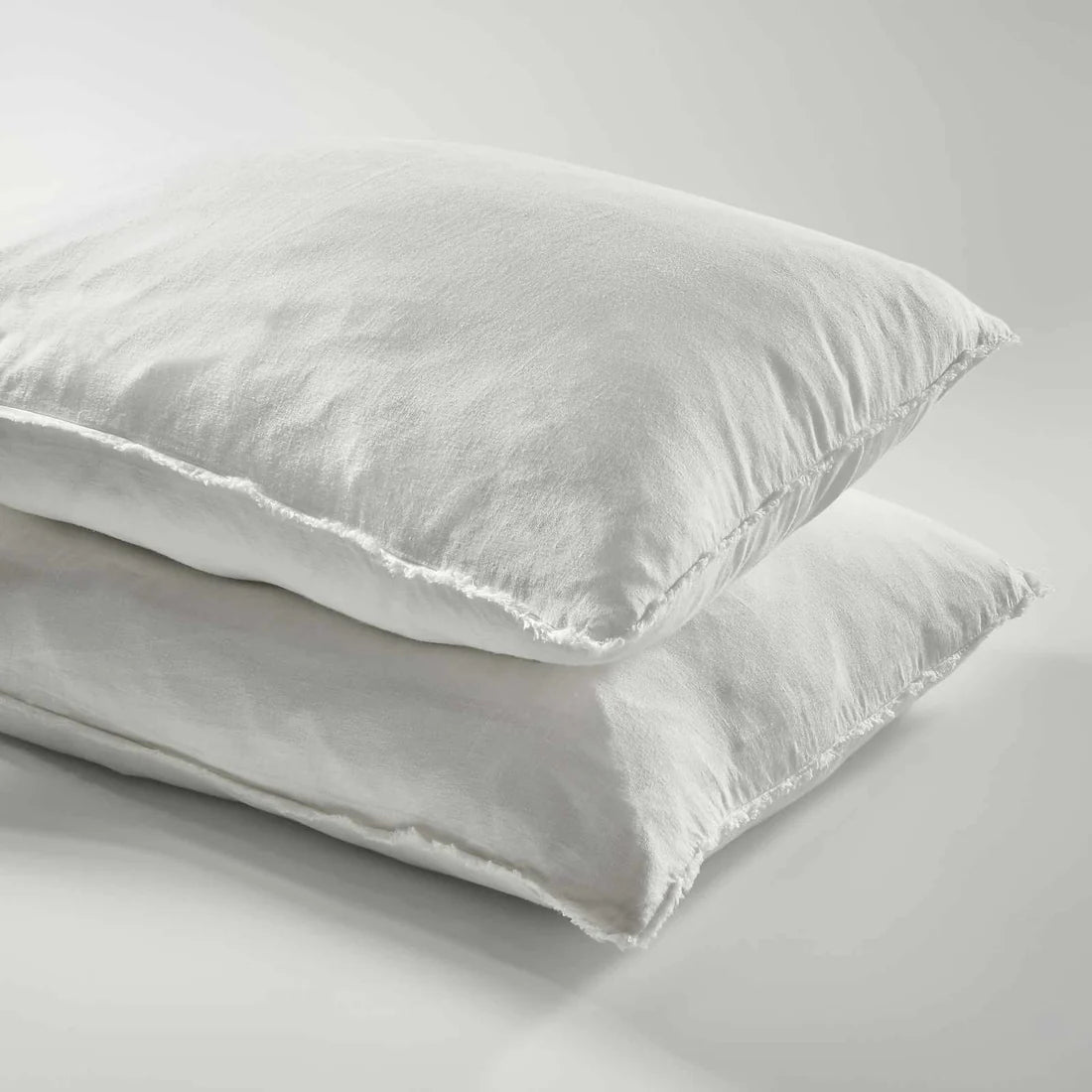 Two white pillows on a light gray background