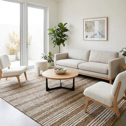 Modern living room with beige sofa, white chairs, and a coffee table.