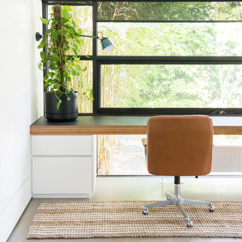 Modern home office with a desk, chair, and large window