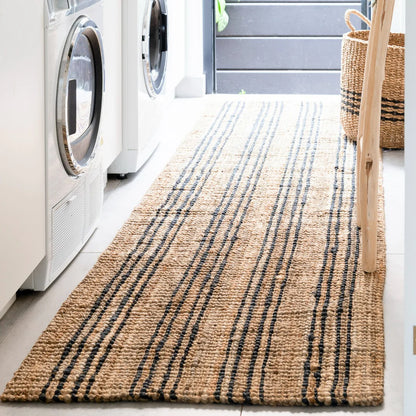 Laundry room with a striped rug, washing machines, and a basket.