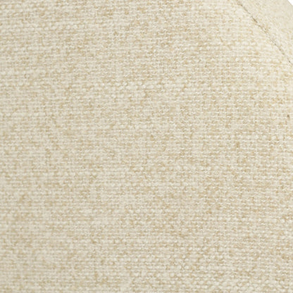 Close-up of a textured woven fabric in a warm cream or light beige color, showing the material grain and a curved seam against a white background.