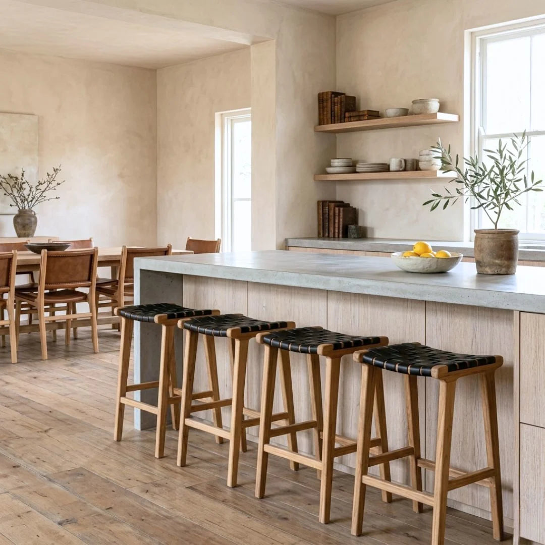 Sun Republic Otis black woven leather and teak counter stools in a modern kitchen