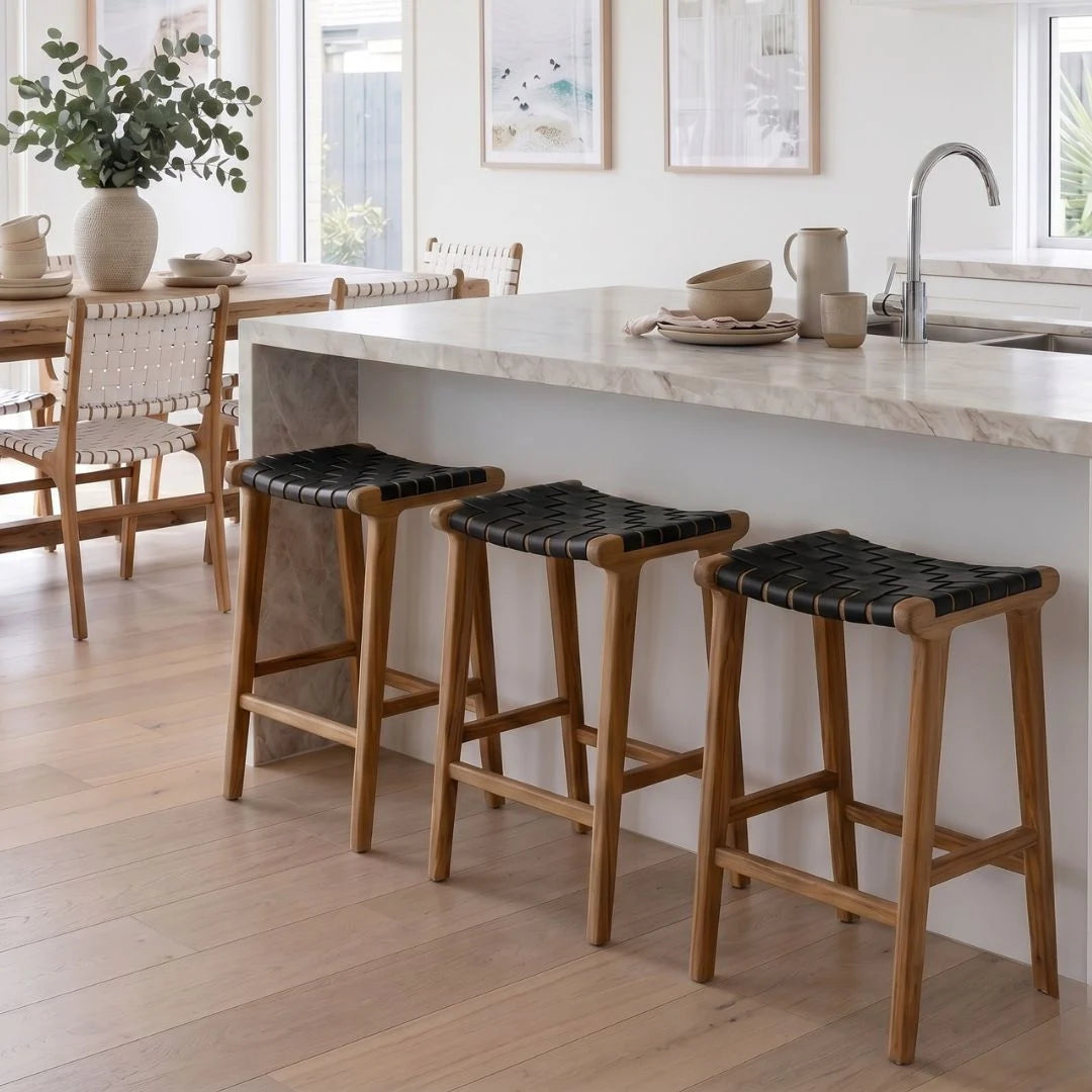 Sun Republic Otis black woven leather and teak counter stools in a modern kitchen