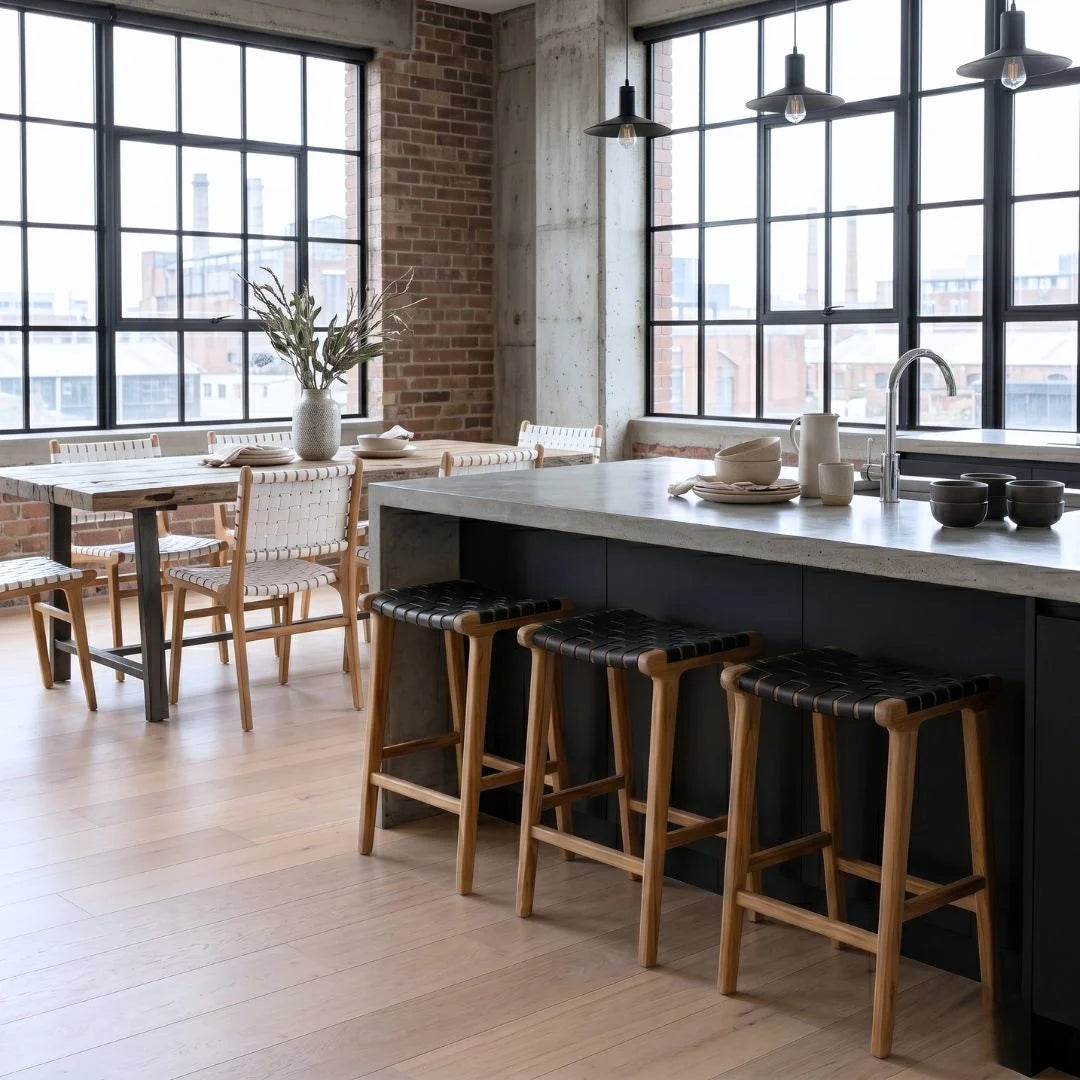 Sun Republic Otis black woven leather and teak counter stools in a modern kitchen