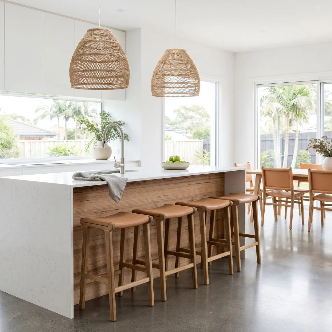 Sun Republic Natural Tan Leather and Teak stools in front of a kitchen counter in a modern open plan kitchen and dining room