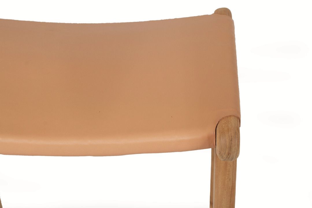 Close-up of a brown natural leather tan counter stool on a white background