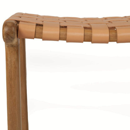 Close-up of a woven leather stool with wooden legs on a white background