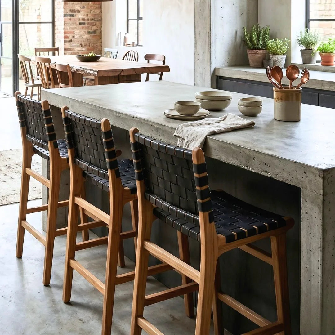 Black woven leather and teak kitchen counter stools in a modern home at a kitchen island bench