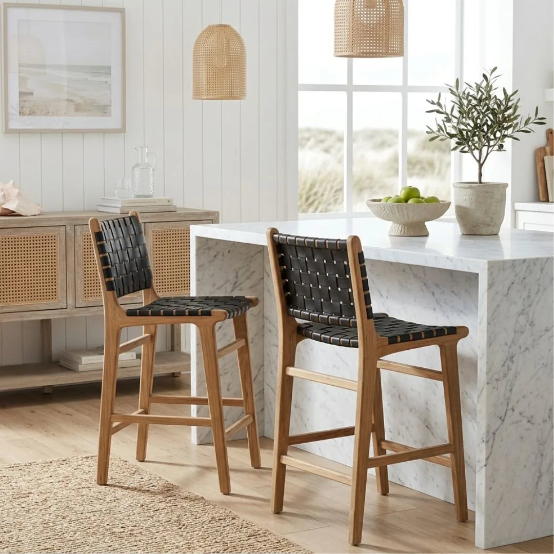 Black woven leather and teak kitchen counter stools in a modern home at a kitchen island bench
