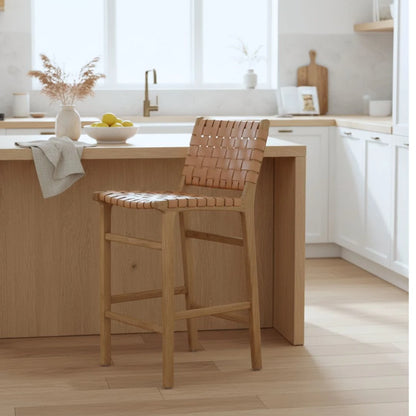 Natural tan woven leather and teak counter stools in a modern kitchen