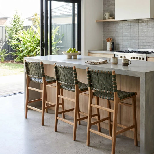 Sun Republic Otis olive leather and teak counter stools at an kitchen island bench in a modern kitchen