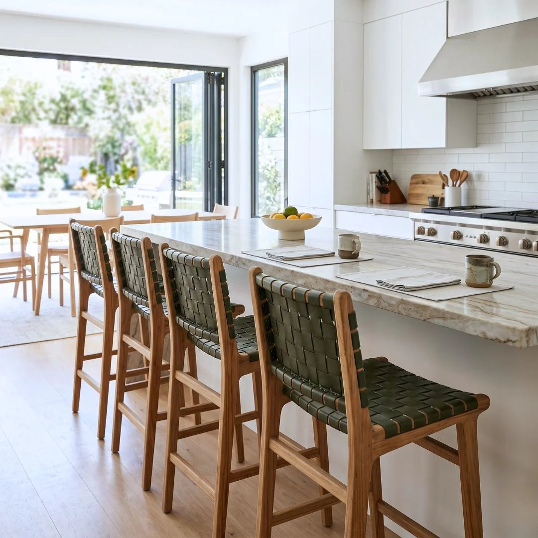 Sun Republic Otis olive leather and teak counter stools at an kitchen island bench in a modern kitchen