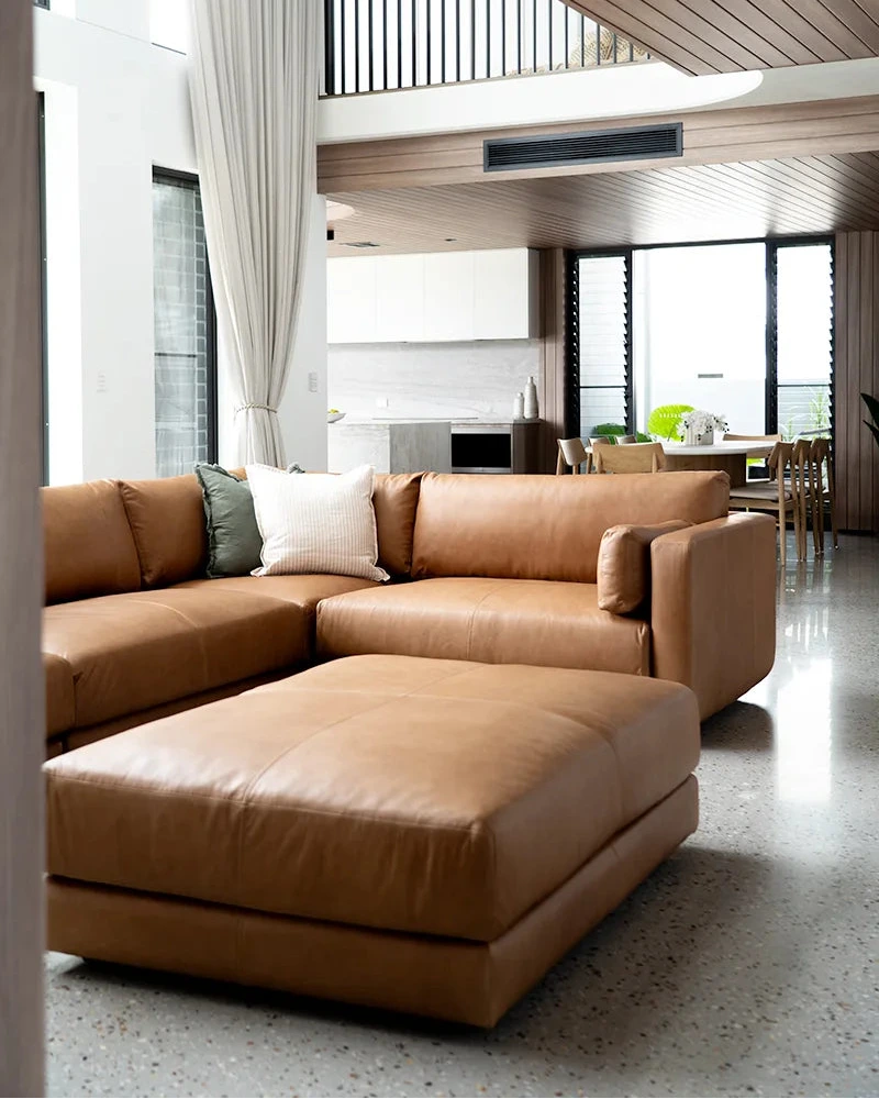 Modern living room with a large brown sectional sofa.