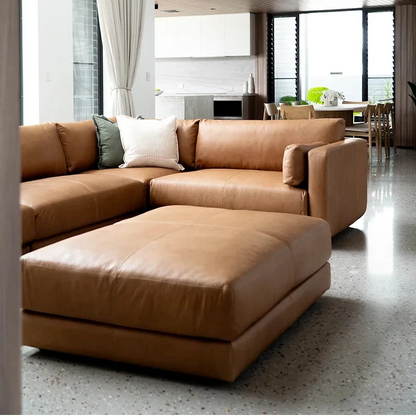 Modern living room with a large brown sectional sofa.