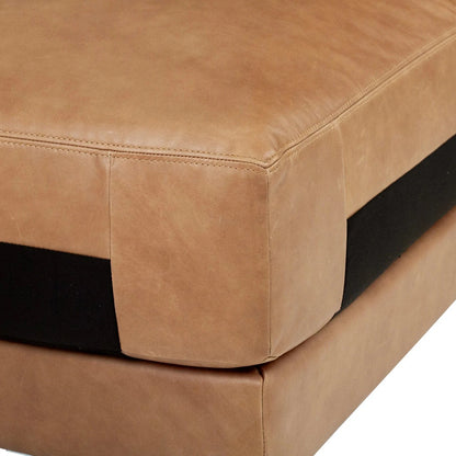 Close-up of a brown leather ottoman with a white background