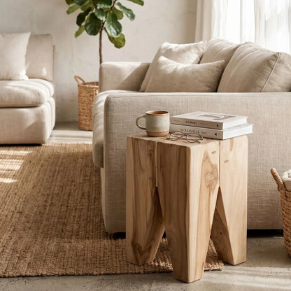 Square teak side table next to a sofa