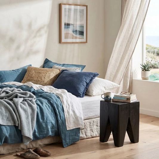 Black Teak square peg stump stool in a modern bedroom
