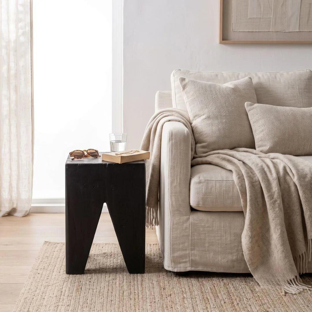 Solid Teak stump Black side table styled in a modern home. 