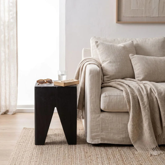 Solid Teak stump Black side table styled in a modern home. 
