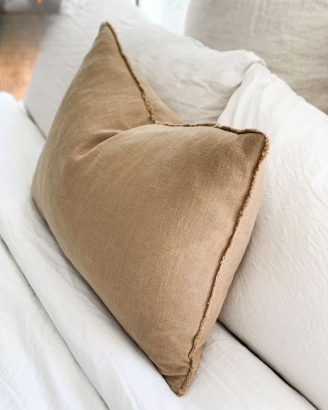 Brown pillow on a white sofa